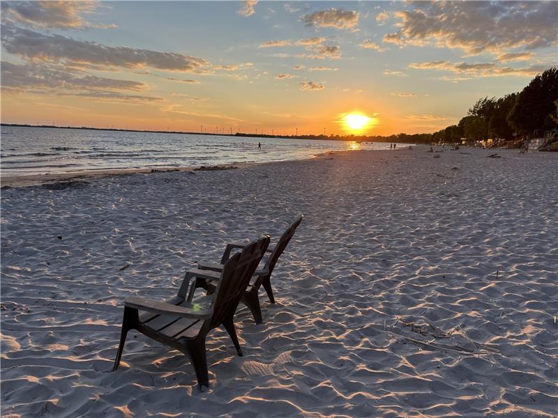 A genuine beach house with stairs to a private sandy beach!