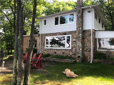 B'Haven Lakehouse - a warmly renovated two story home on 220' sandy shoreline waterfront