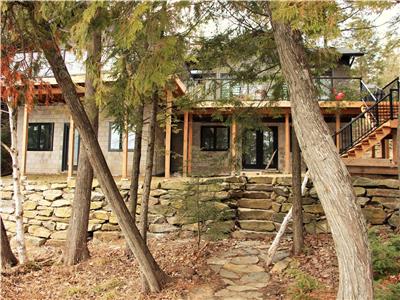 Stunning cottage on sand beach on prestigious Kennisis Lake!