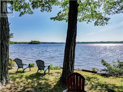 Waterfront cottage with private sandy beach on golden lake perfect for family fun