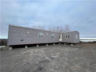 Explore this luxurious resort cottage model with beautiful views of Rice Lake!