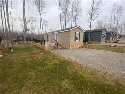 Step into your own oasis nestled in the forest with this resort cottage!